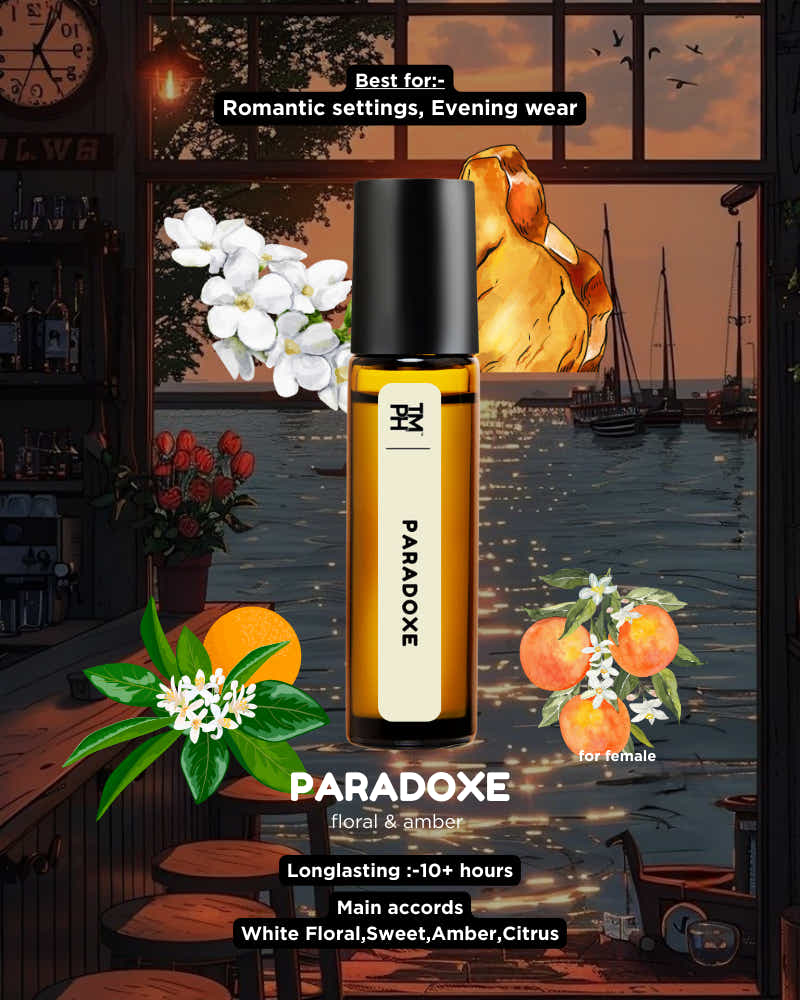 Paradoxe perfume bottle with floral and orange elements in a romantic setting.