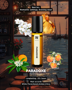 Paradoxe perfume bottle with floral and orange elements in a romantic setting.