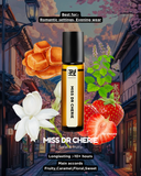 Miss Dr Cherie perfume bottle with floral, fruit, and architectural elements in the background