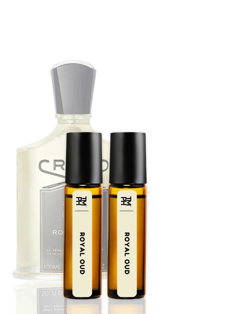 Set of perfume bottles including a large bottle and two smaller rollerball bottles on a white background