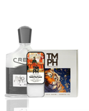 Collection of Creed perfume bottle, solid perfume, and a box with a tiger design on a white background